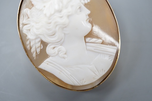 A yellow metal mounted oval cameo shell brooch, carved with the bust of a lady to sinister, 47mm, gross weight 16.7 grams.